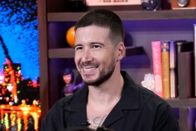 Vinny Guadagnino smiling and wearing a black shirt on the set of Watch What Happens Live