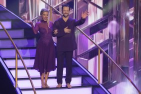 Ariana Madix and Pasha Pashkov wearing purple dance costumes and waving while standing on a staircase