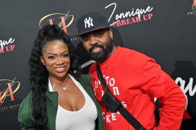 Kandi Burruss and Todd Tucker posing together; Kandi is wearing a green jacket with a white T-shirt. Todd is wearing a red sweater and a New York Yankees hat.