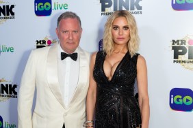 PK Kemsley in a white tuxedo standing with Dorit Kemsley who is wearing a black dress.