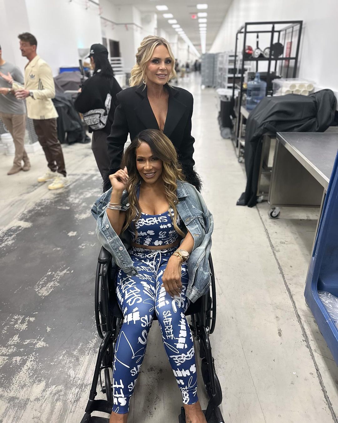 Shereé Whitfield in a wheelchair at BravoCon 2023 in Las Vegas, being pushed by Tamra Judge