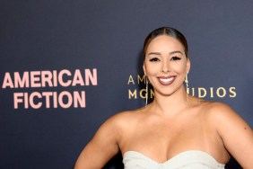 Gloria Govan in a white dress and smiling.