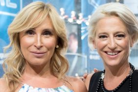 Sonja Morgan in a blue and white floral dress, standing next to Dordina Medley who's smiling and wearing a black dress