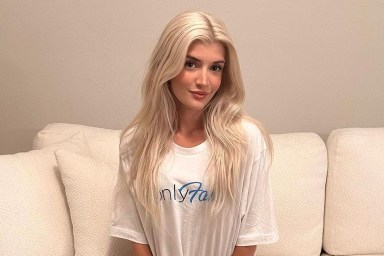 Sami Sheen sitting on a couch wearing a white OnlyFans t-shirt.