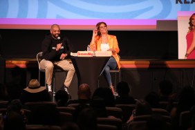 Robyn Dixon and Juan Dixon on stage at a live Reasonably Shady podcast event, Robyn is wearing an orange blazer and Juan is wearing a black hoodie