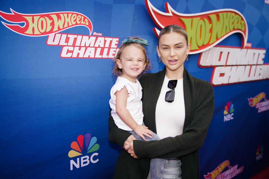 Lala Kent in a black blazer holding her daughter Ocean Kent.