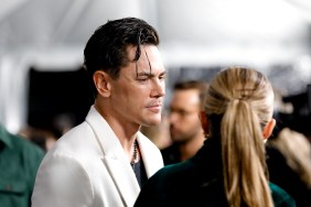 A side profile of Tom Sandoval at the Season 11 Vanderpump Rules premiere; he's wearing a white blazer and looking to a woman with a blonde ponytail