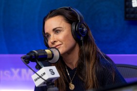 Kyle Richards speaking into a microphone and wearing a pair of headphones at Sirius XM studios