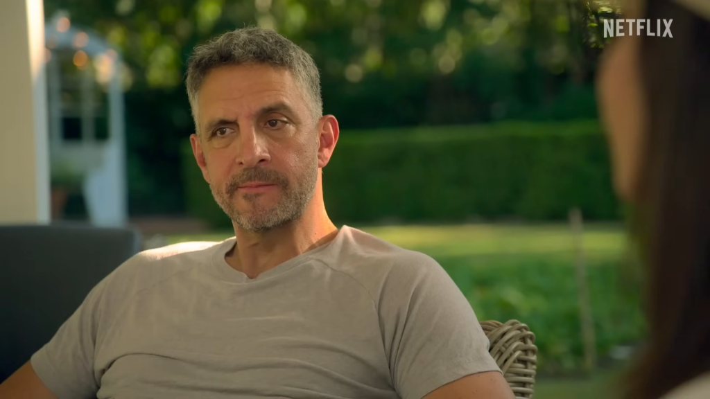 Mauricio Umansky sitting outside in a grey t-shirt with a serious look on his face in Buying Beverly Hills Season 2