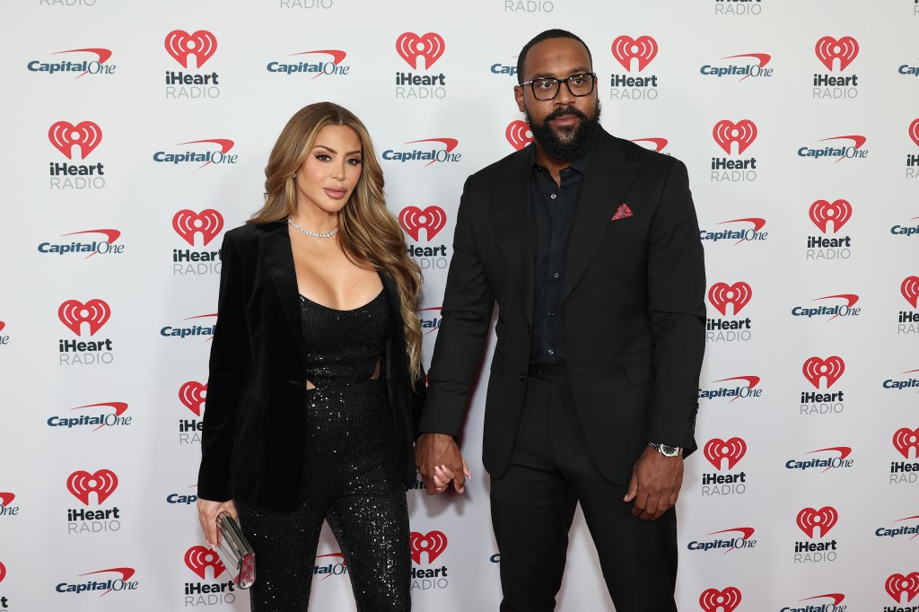 Marcus Jordan and Larsa Pippen at an iHeartRadio event, wearing black suits and holding hands