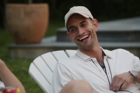 Jesse Soloman grinning and sitting outside in a white chair and wearing an all white outfit on Summer House Season 8