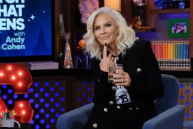 Jenny McCarthy in a black outfit, drinking out of a glass and making a thinking gesture while appearing in an episode of Watch What Happens Live
