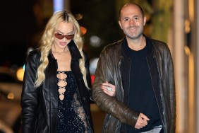 Christine Quinn in a black dress and black sunglasses walking with husband Christian Richard at nighttime