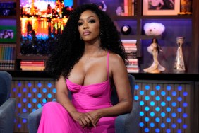 Porsha Williams on Watch What Happens Live, wearing a pink dress, sitting with her legs crossed, and making a serious facial expression