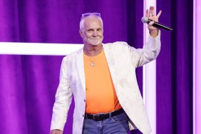 Captain Lee Rosbach waving to the crowd at BravoCon 2023 while wearing an orange shirt and a white jacket