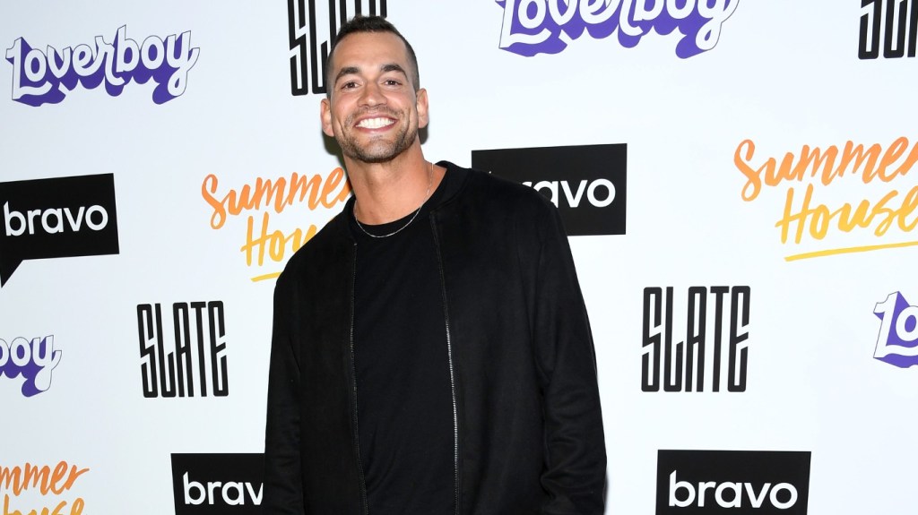 Jesse Solomon posing in an all-black outfit while smiling