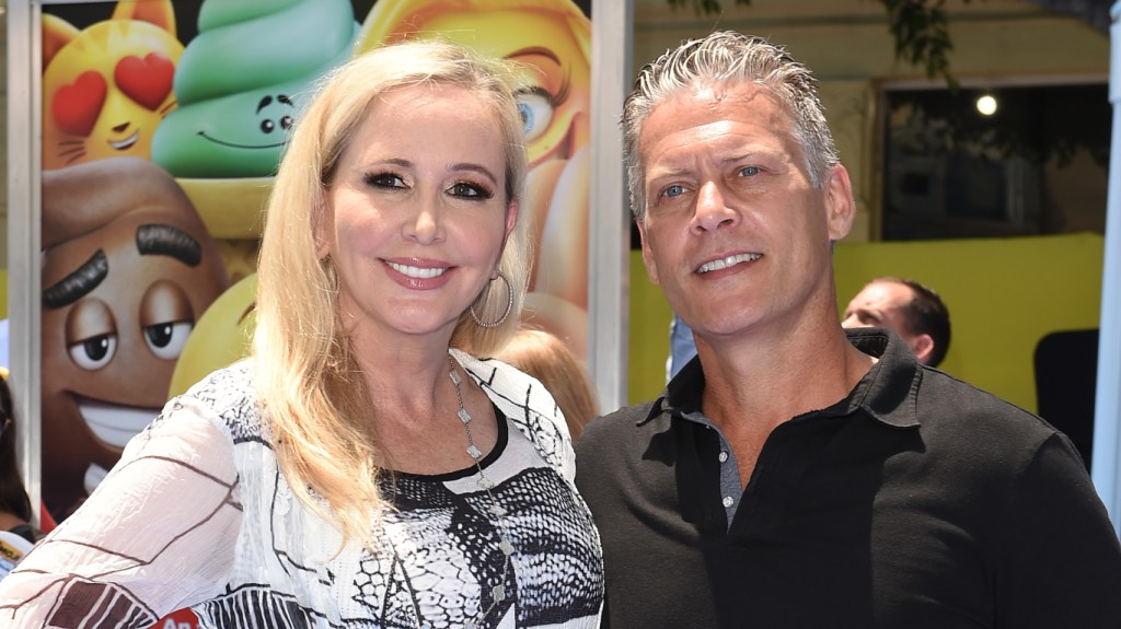Shannon Beador in a white top posing with David Beador, who is wearing a black shirt with a collar