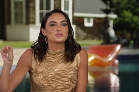 Paige DeSorbo in a gold dress during a Summer House Season 8 confessional interview; she's pointing her finger in an passionate gesture