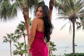 Jenn Trann in a pink dress doing an over the shoulder pose in front of palm trees