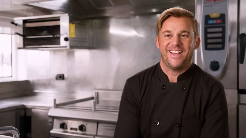 Chef Nick Tatlock smiling in a confessional interview on Below Deck Season 11