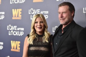 Tori Spelling and Dean McDermott wearing black and posing together on a red carpet