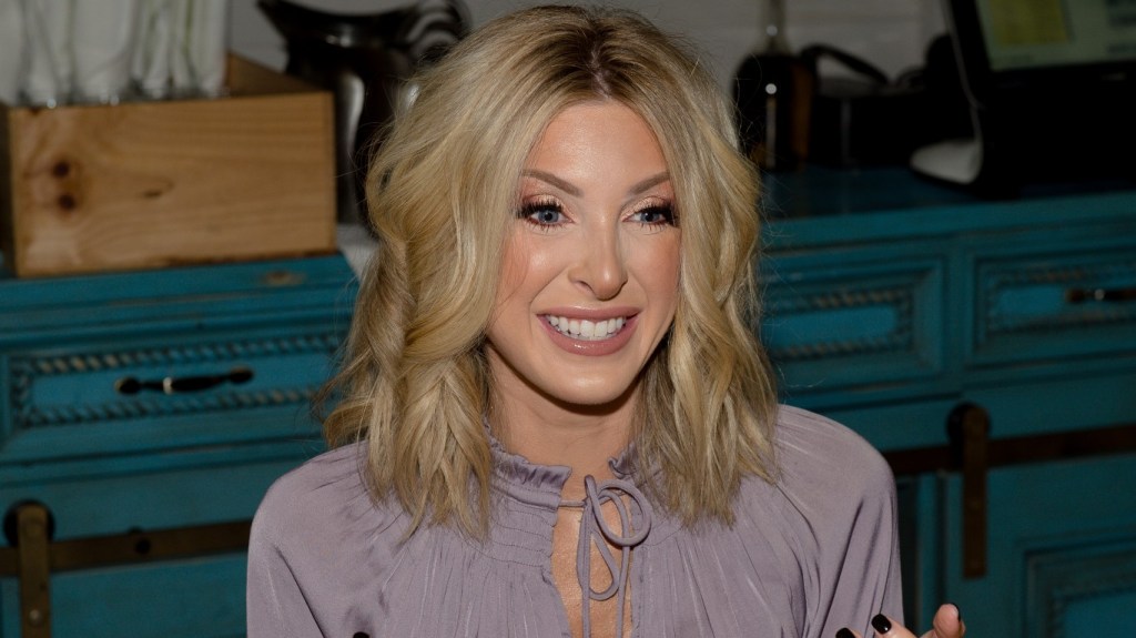 Lindsie Chrisley smiling and wearing a purple dress