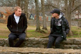 Todd Chrisley and Grayson Chrisley wearing black hoodies and sitting across from each other on Chrisley Knows Best