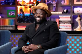 Preston Mitchum on Watch What Happens Live, smiling, wearing a black shirt and a brown hat