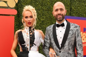 Christine Quinn and Christian Richard posing together in black and white outfits