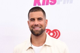 Blake Moynes smiling and posing in a white button up shirt