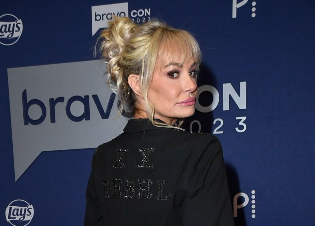 Taylor Armstrong in a black blazer doing an over the shoulder pose at BravoCon 2023