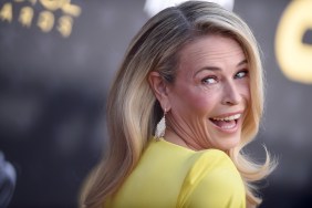 Chelsea Handler in a yellow dress doing an over the shoulder pose and making a silly face