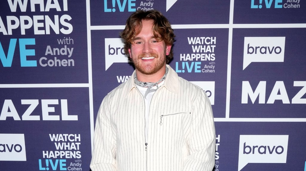 West Wilson in a white suit posing and smiling backstage at Watch What Happens Live