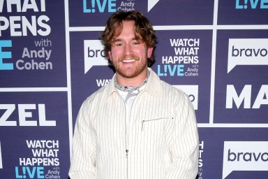 West Wilson in a white suit posing and smiling backstage at Watch What Happens Live