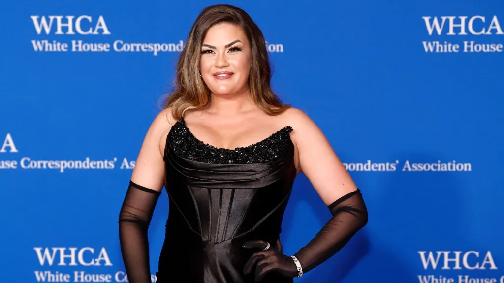 Brittany Cartwright in a black dress posing on the red carpet at the White House Correspondents Dinner