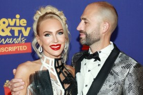 Christian Richard and Christine Quinn on a red carpet; Christian has his head turned to the side and is staring at Christine