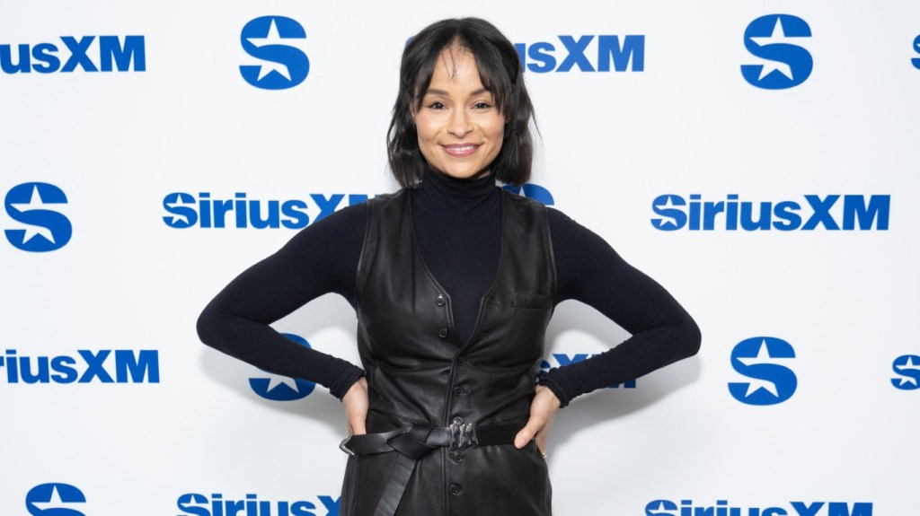Sai De Silva at Sirius XM Studios standing with her hands on her hips in an all-black outfit