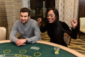 Rachel Lindsay at Bryan Abasolo sitting at a casino table and smiling