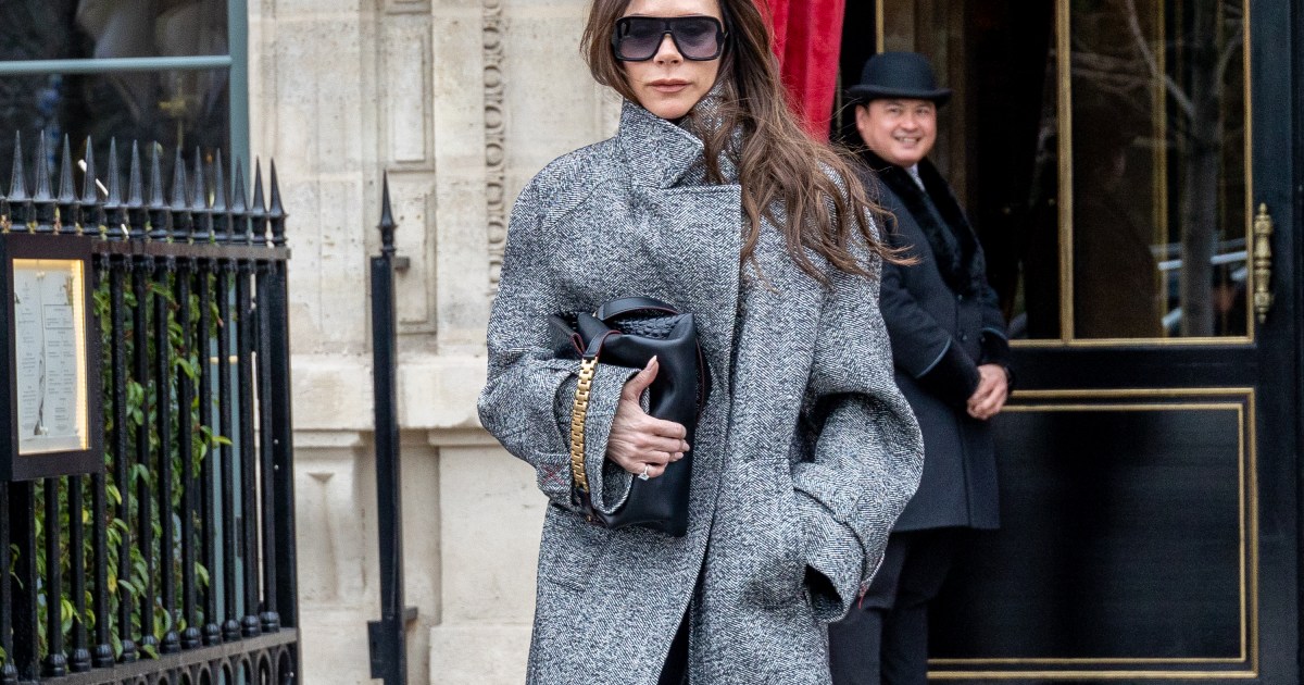 Victoria Beckham in a grey coat holding a clutch