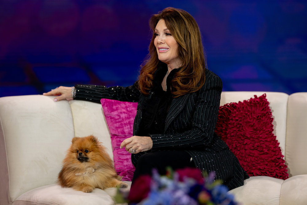 Lisa Vanderpump on a chat show with her little dog.