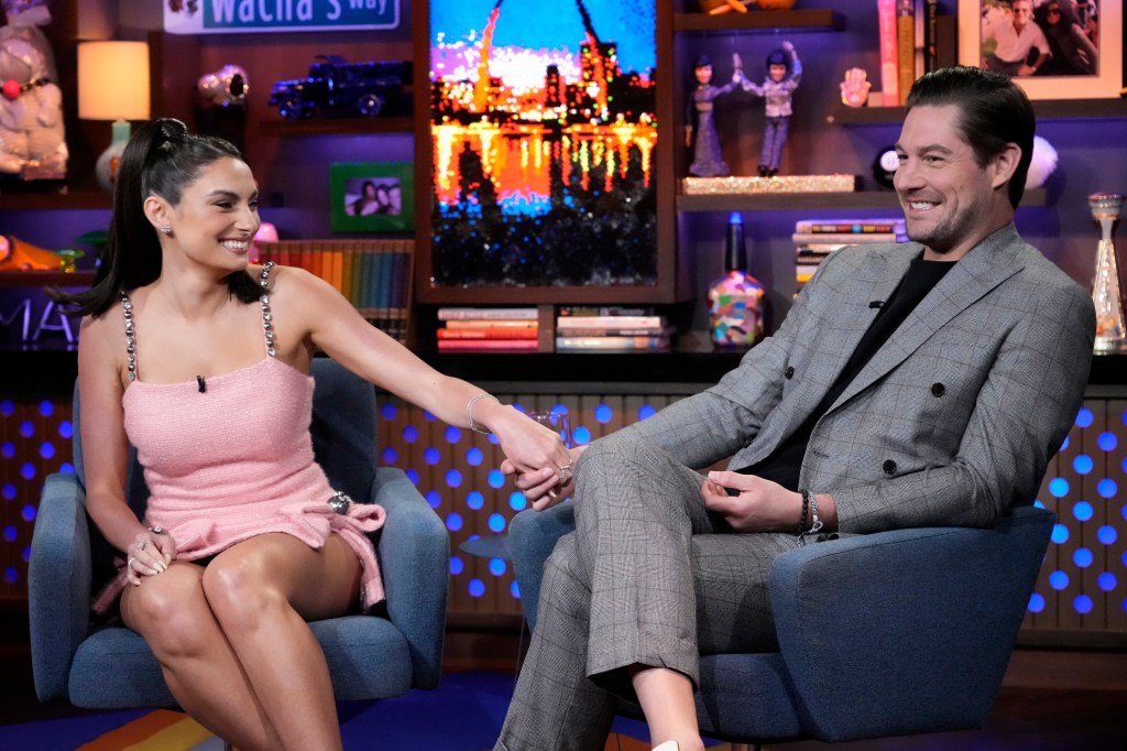 Paige DeSorbo and Craig Conover holding hands on WWHL.
