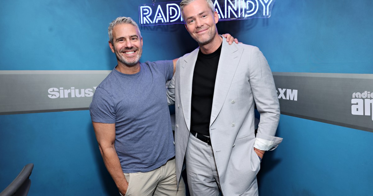 Andy Cohen and Ryan Serhant posing together at SiriusXM studios