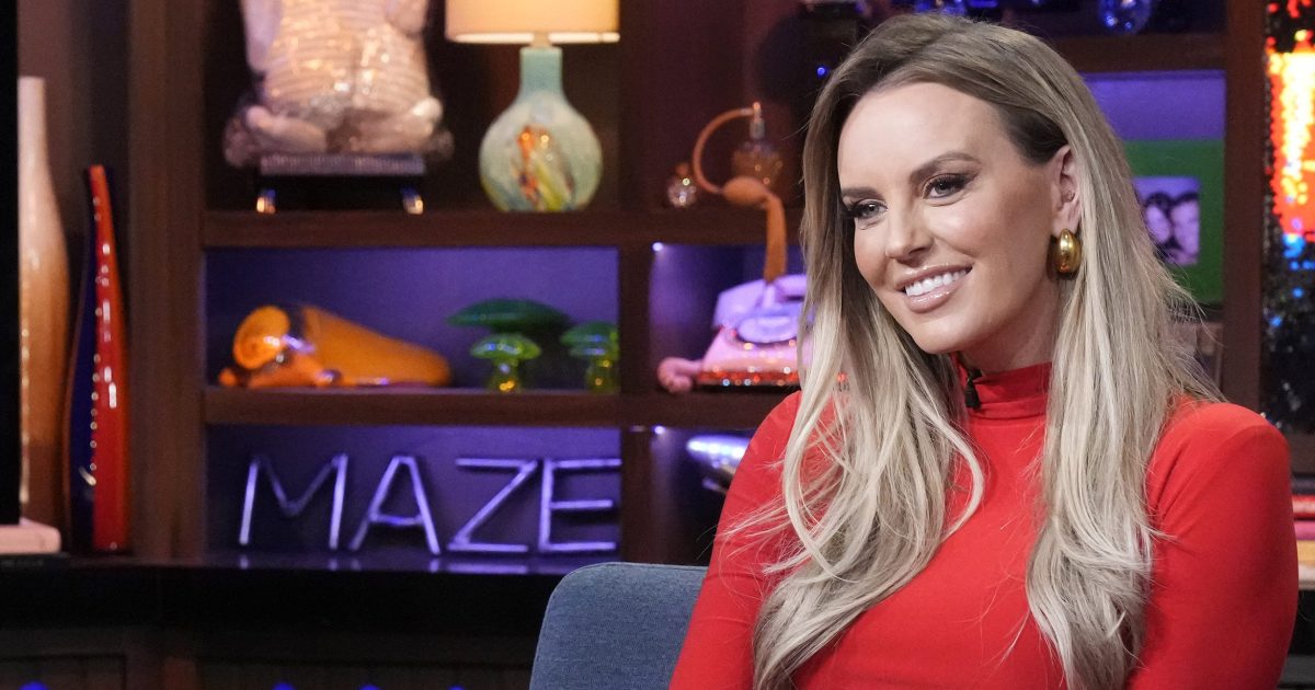 RHOSLC star Whitney Rose in a red dress and smiling on WWHL.