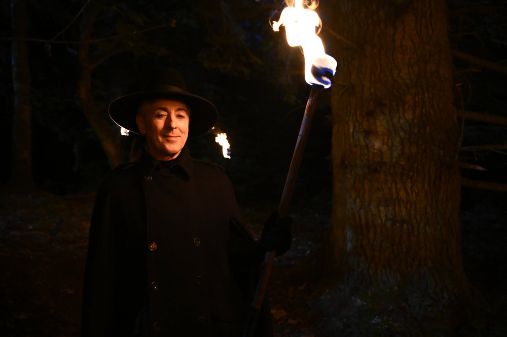 Alan Cumming walking with a torch on The Traitors Season 3