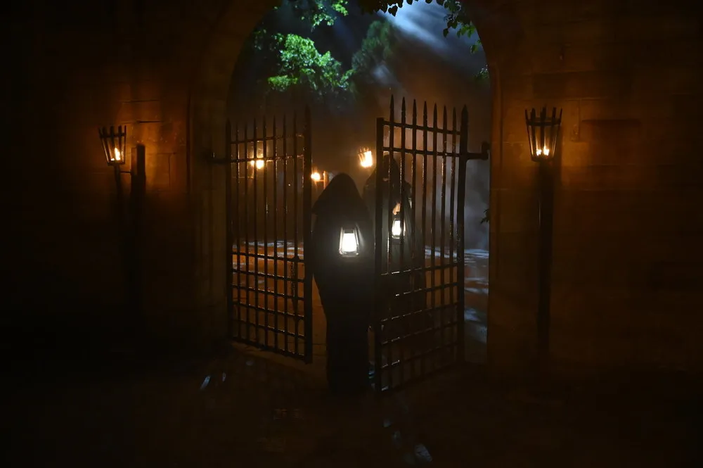 Two Traitors walking through the castle grounds in Season 3 of The Traitors