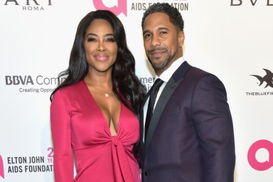 Kenya Moore and Marc Daly posing on a red carpet