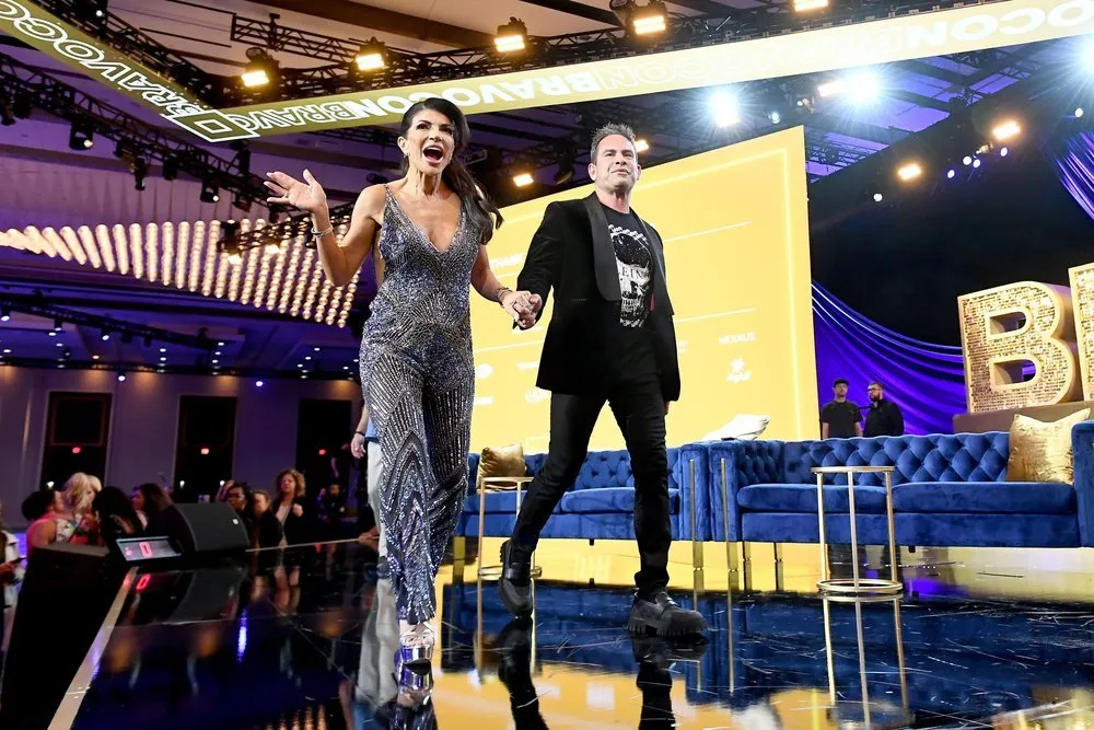 Teresa Giudice and Luis Ruelas walking across stage at BravoCon
