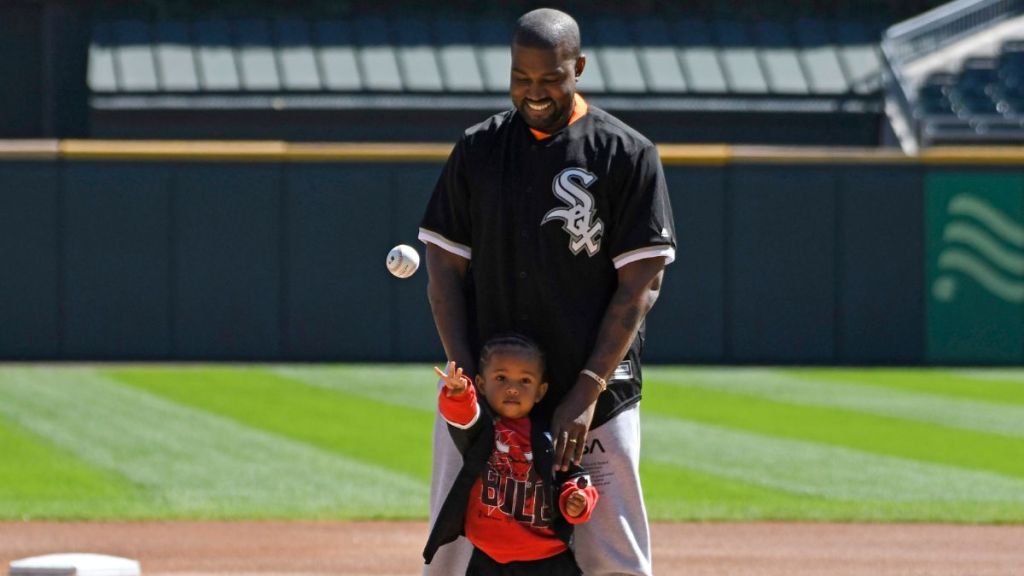 Kanye West and his son Saint throw out a ceremonial first pitch before the game between the Chicago White Sox and the Chicago Cubs on September 23, 2018 at Guaranteed Rate Field in Chicago, Illinois.