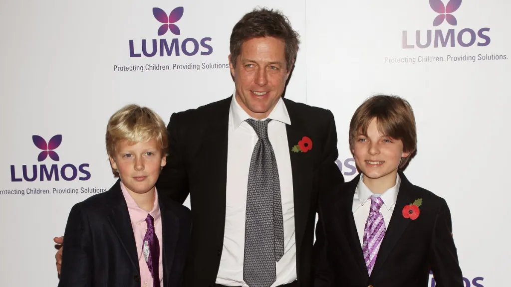 Hugh Grant (C) and Damian Hurley, son of Elizabeth Hurley, attend the Lumos fundraising event hosted by J.K. Rowling at The Warner Bros. Harry Potter Tour on November 9, 2013 in London, England.