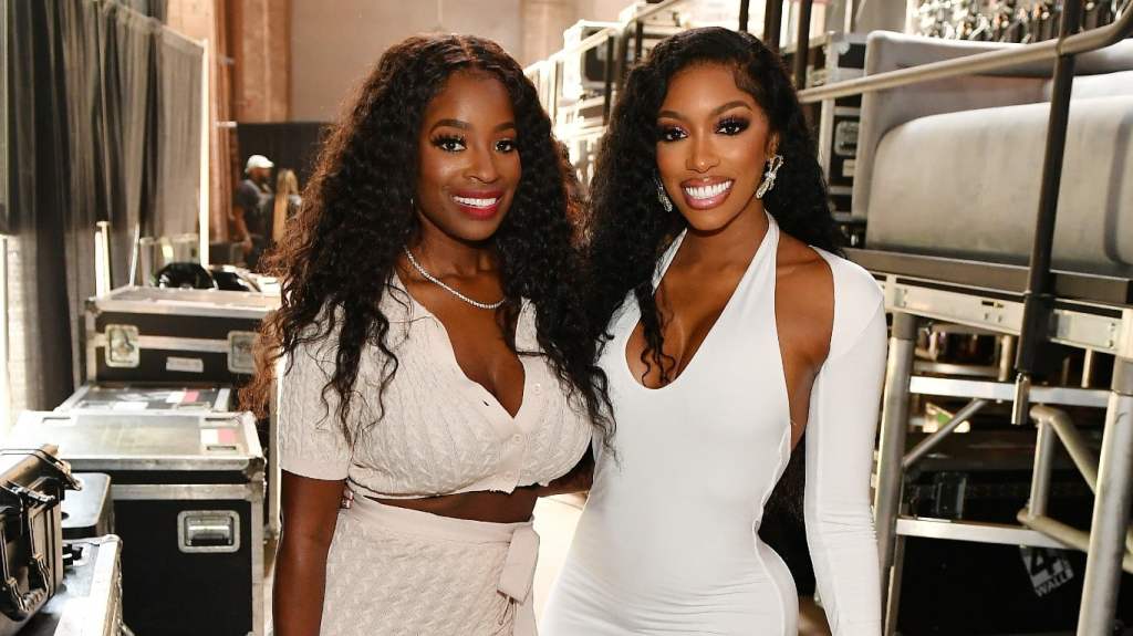 Shamea Morton and Porsha Williams posing together and wearing white dresses